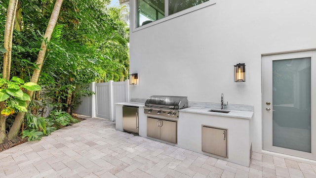 view of patio / terrace featuring grilling area, sink, and exterior kitchen