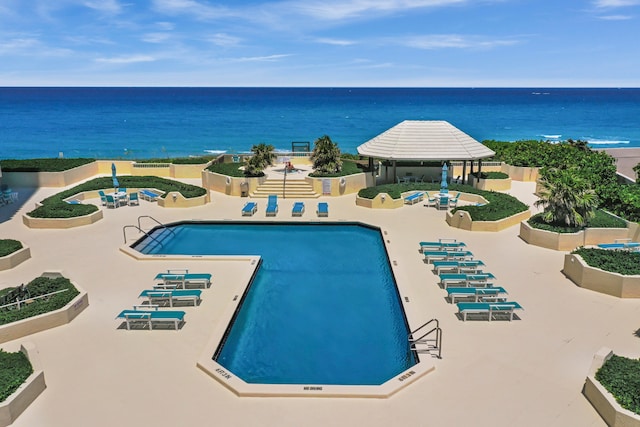 view of swimming pool featuring a patio, a water view, and a gazebo