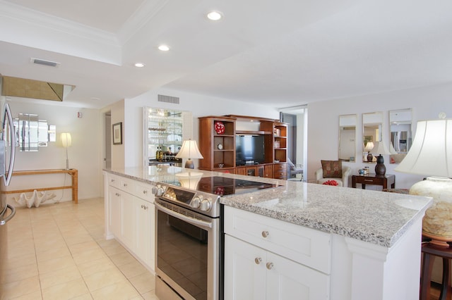 kitchen featuring white cabinetry, light stone counters, ornamental molding, stainless steel electric range, and a center island