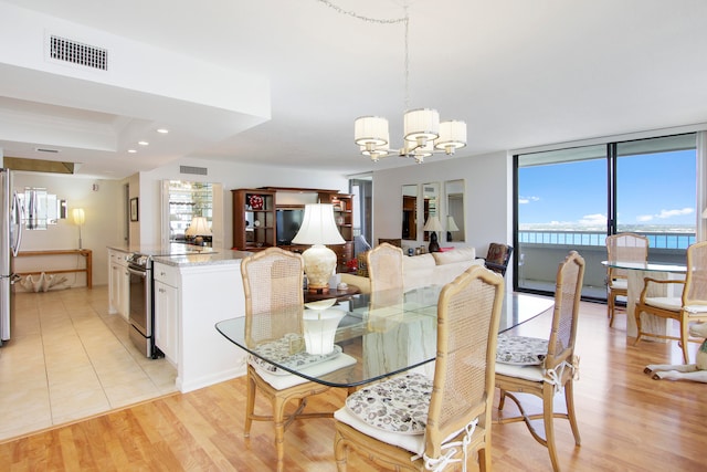 dining area featuring a chandelier and light hardwood / wood-style flooring