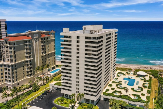 birds eye view of property with a water view and a view of the beach