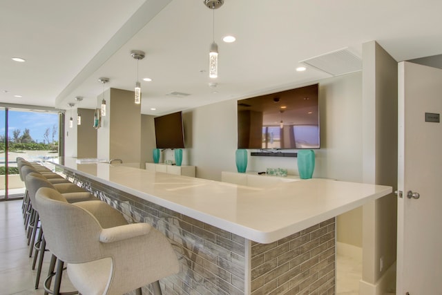 kitchen with hanging light fixtures and a kitchen breakfast bar