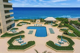 view of pool with a patio area and a water view