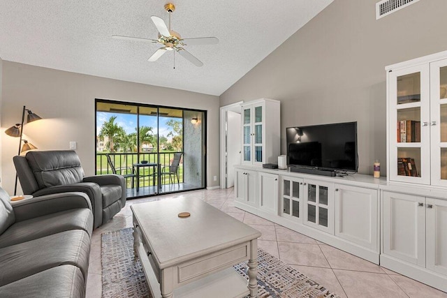 tiled living room with a textured ceiling, high vaulted ceiling, and ceiling fan
