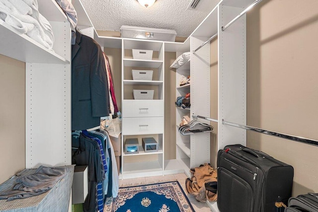 spacious closet with tile patterned floors