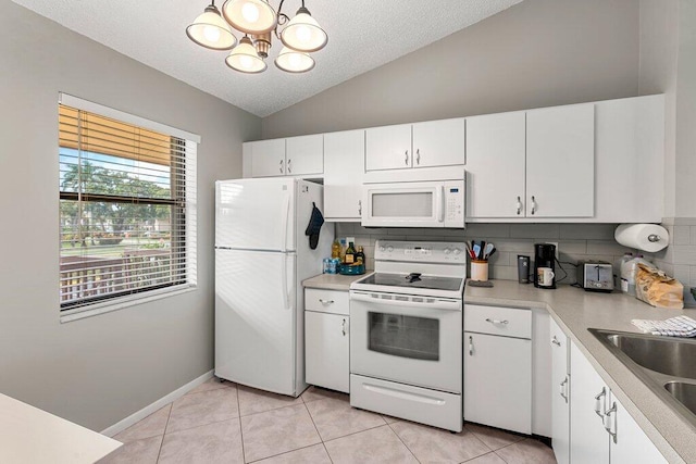 kitchen with white cabinetry, decorative backsplash, lofted ceiling, and white appliances