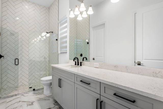 bathroom featuring vanity, toilet, and an enclosed shower