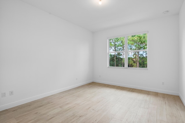 empty room with light hardwood / wood-style flooring