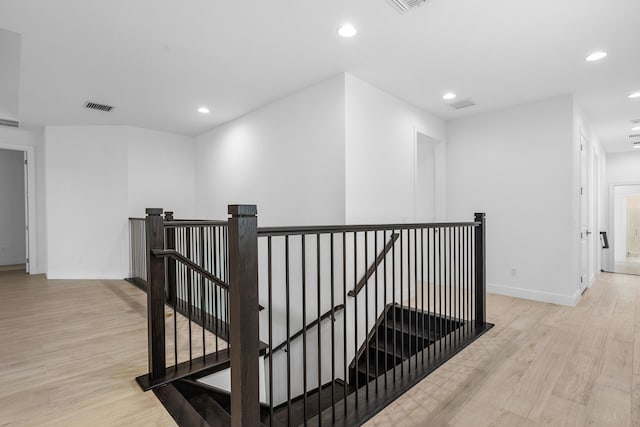 corridor with light hardwood / wood-style flooring