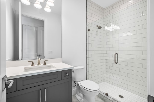 bathroom with vanity, toilet, and walk in shower