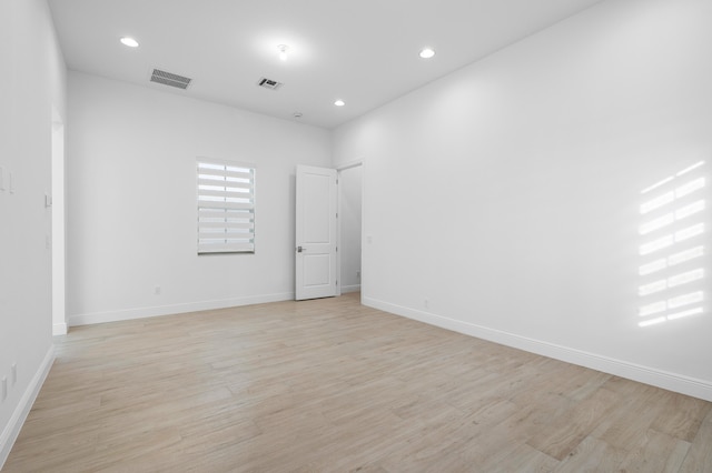 unfurnished room with light wood-type flooring