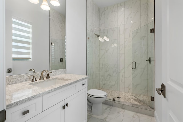 bathroom featuring vanity, toilet, and an enclosed shower