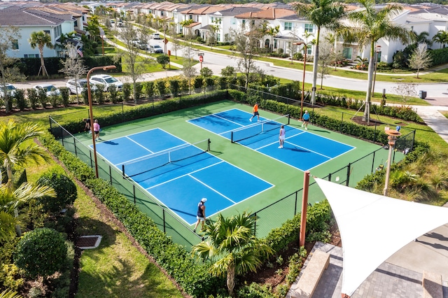 view of tennis court with basketball hoop