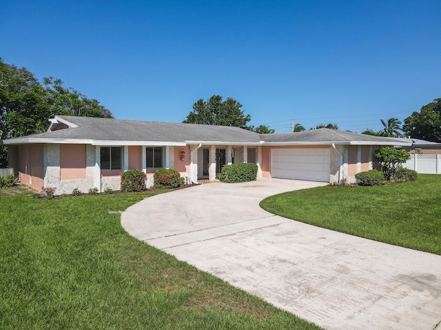 single story home with a garage and a front lawn