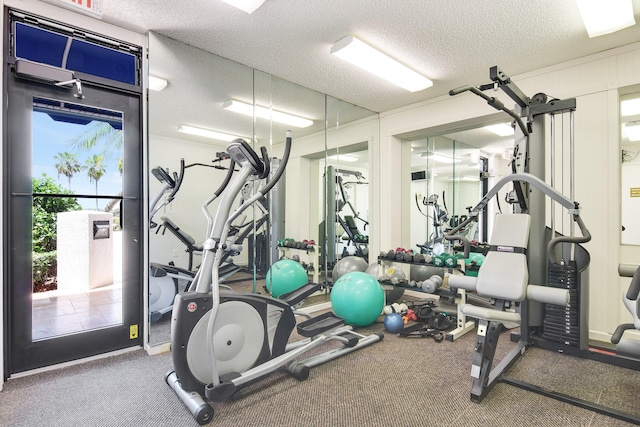 exercise room with a textured ceiling