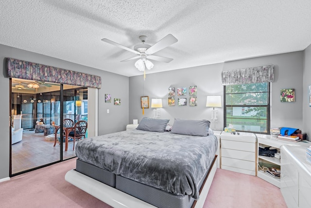 carpeted bedroom with access to outside, a textured ceiling, and ceiling fan