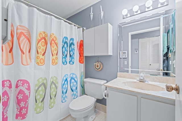 bathroom featuring vanity, walk in shower, tile patterned floors, and toilet