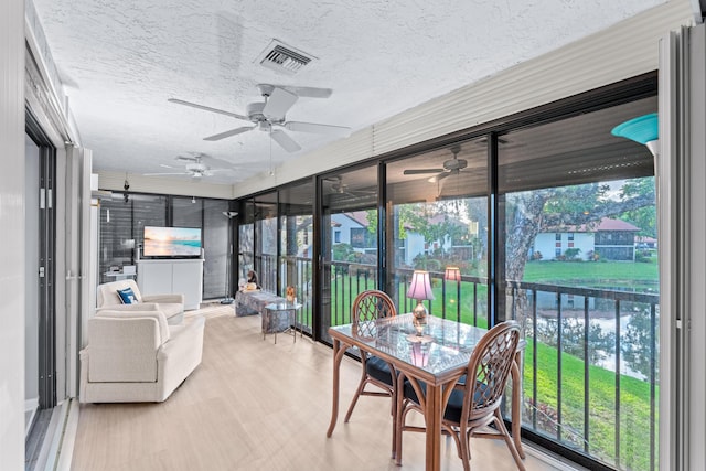 sunroom / solarium with ceiling fan and a healthy amount of sunlight