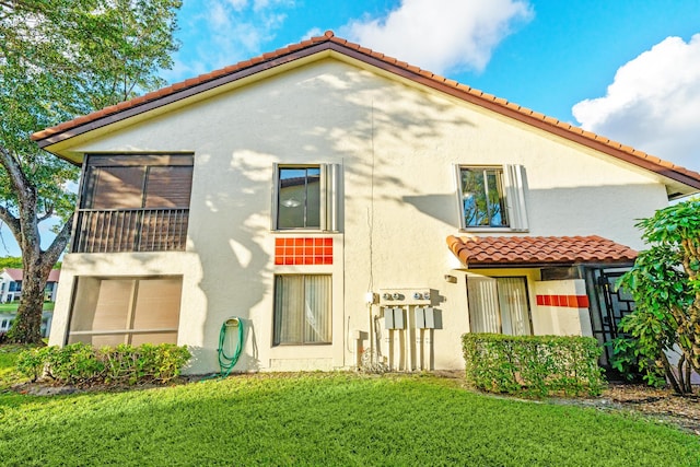 back of property featuring a lawn