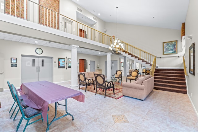 interior space featuring high vaulted ceiling, a chandelier, and decorative columns