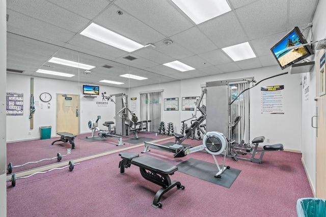 exercise room featuring carpet and a drop ceiling