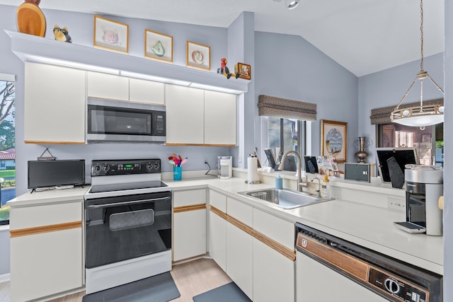 kitchen featuring vaulted ceiling, hanging light fixtures, sink, white cabinetry, and white appliances