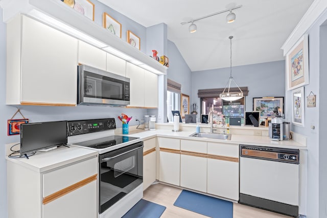 kitchen with sink, light wood-type flooring, white appliances, white cabinets, and pendant lighting