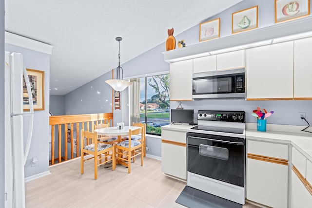 kitchen with hanging light fixtures, white appliances, white cabinetry, and vaulted ceiling