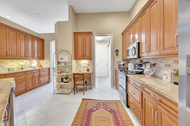 kitchen with stainless steel appliances, light stone countertops, light tile patterned floors, and backsplash