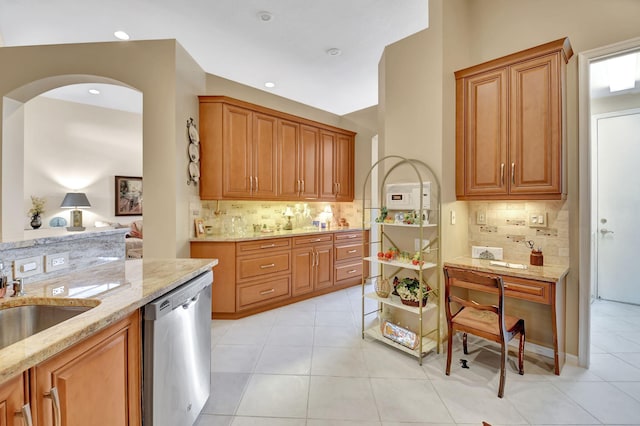 kitchen featuring light tile patterned flooring, light stone countertops, backsplash, and dishwasher