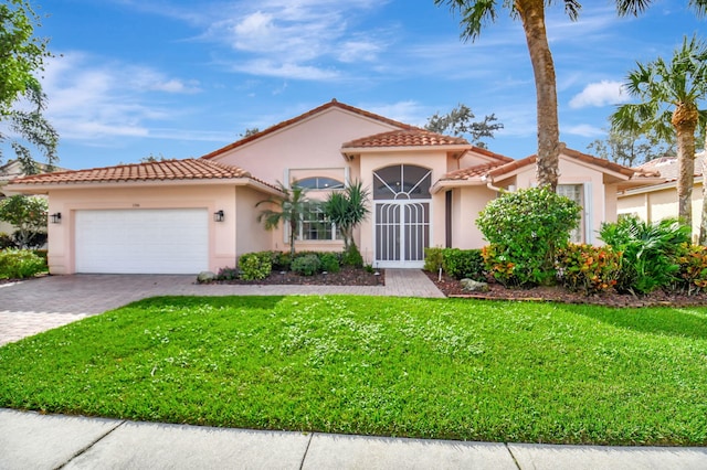 mediterranean / spanish house featuring a front lawn and a garage