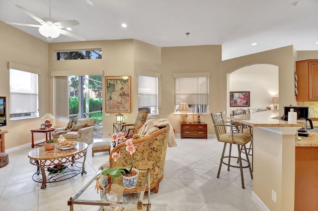 living room with light tile patterned flooring and ceiling fan