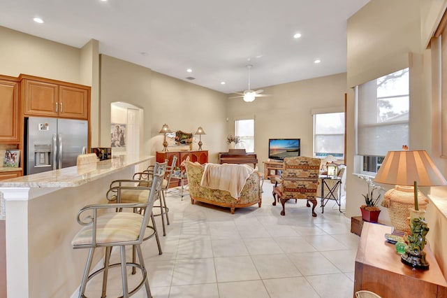 living room featuring ceiling fan and light tile patterned floors