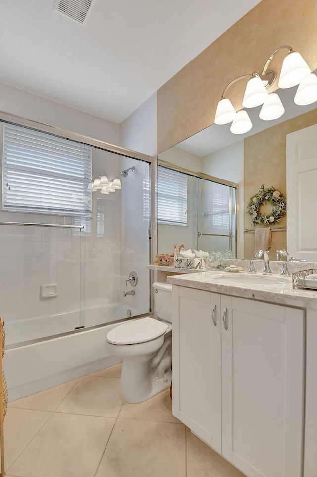 full bathroom featuring tile patterned flooring, vanity, toilet, and enclosed tub / shower combo