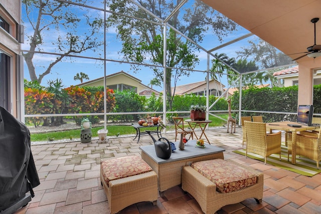 view of patio / terrace with a lanai, area for grilling, and ceiling fan