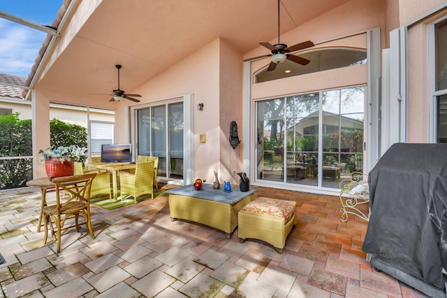 view of patio with ceiling fan and a lanai