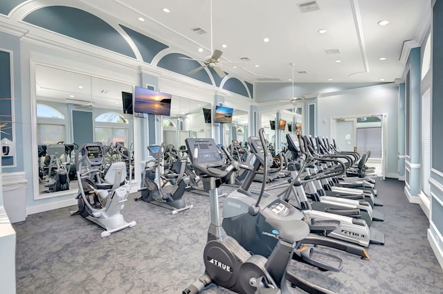 exercise room with ornamental molding, carpet, and ceiling fan