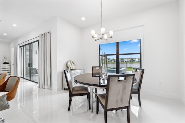 dining room with a notable chandelier, recessed lighting, and baseboards