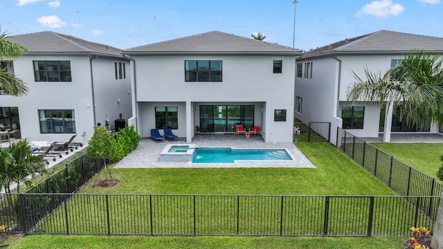 rear view of house with a patio, a fenced backyard, a pool with connected hot tub, a yard, and stucco siding