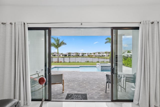 doorway featuring a water view and tile patterned flooring