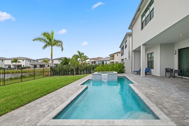 view of swimming pool with a fenced backyard, a residential view, a lawn, and a patio