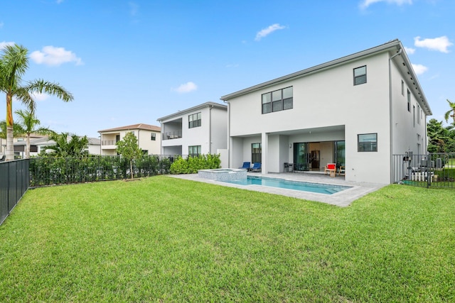 back of property featuring a lawn, a fenced backyard, and stucco siding