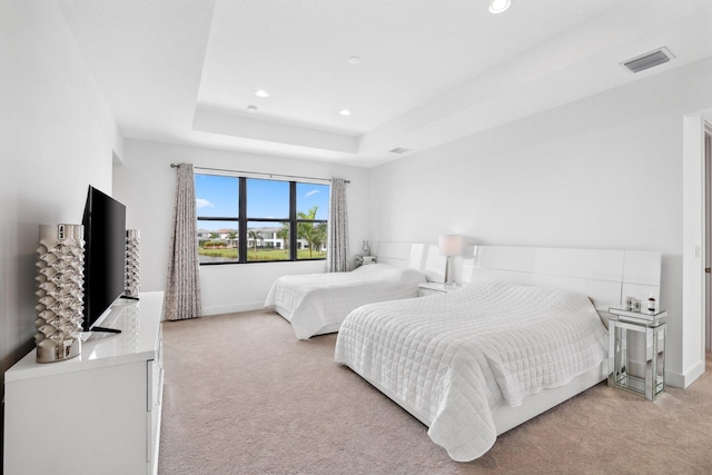 bedroom with recessed lighting, carpet floors, visible vents, baseboards, and a tray ceiling