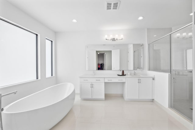 full bathroom featuring a stall shower, a soaking tub, vanity, and recessed lighting