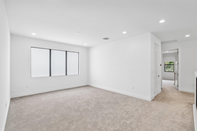 empty room with light carpet, visible vents, and recessed lighting