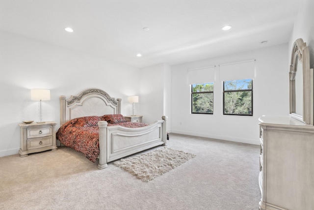 bedroom with baseboards, recessed lighting, and light colored carpet