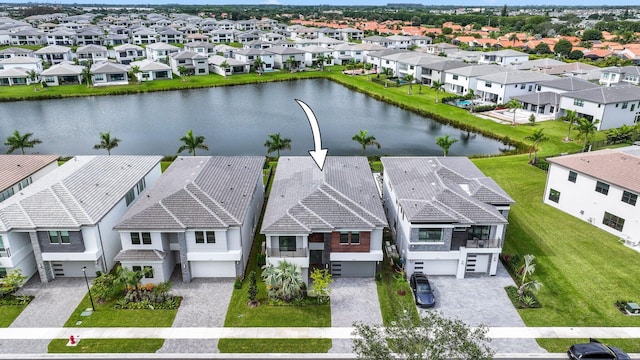 birds eye view of property with a residential view and a water view