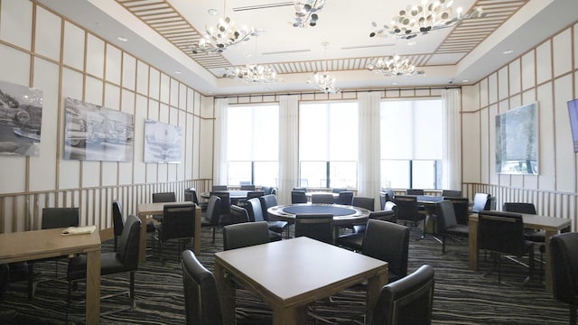 interior space with a tray ceiling and an inviting chandelier