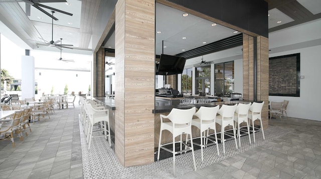 kitchen with ceiling fan, a towering ceiling, and recessed lighting