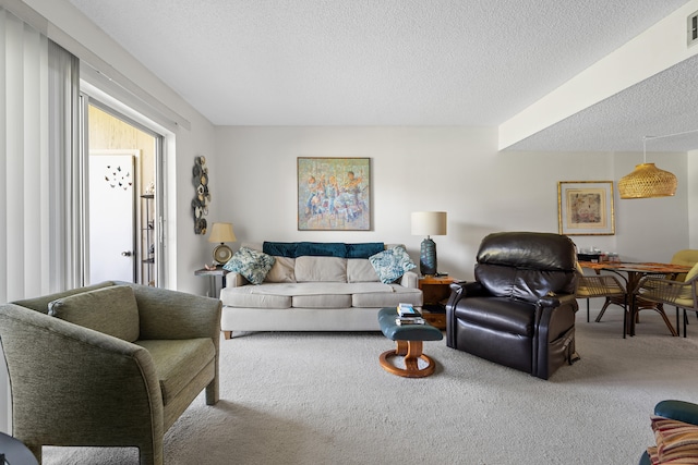 carpeted living room with a textured ceiling